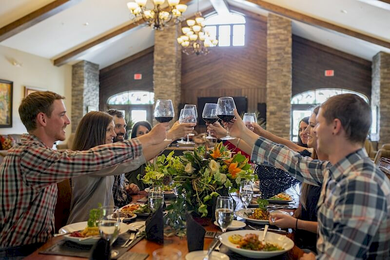People raising a toast around the dinner table